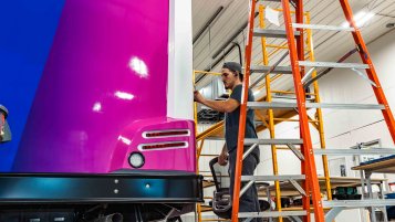 A TESCO Specialty Vehicles technician installing a custom vehicle wrap