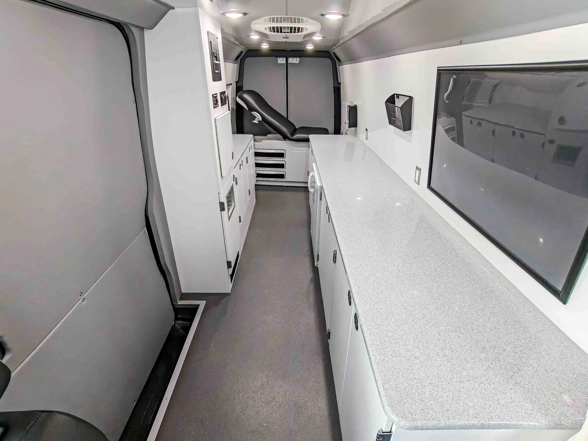 Interior with exam bed of a used 2020 Mercedes-Benz Sprinter Mobile Clinic & Testing Lab (Customizable Build) for sale