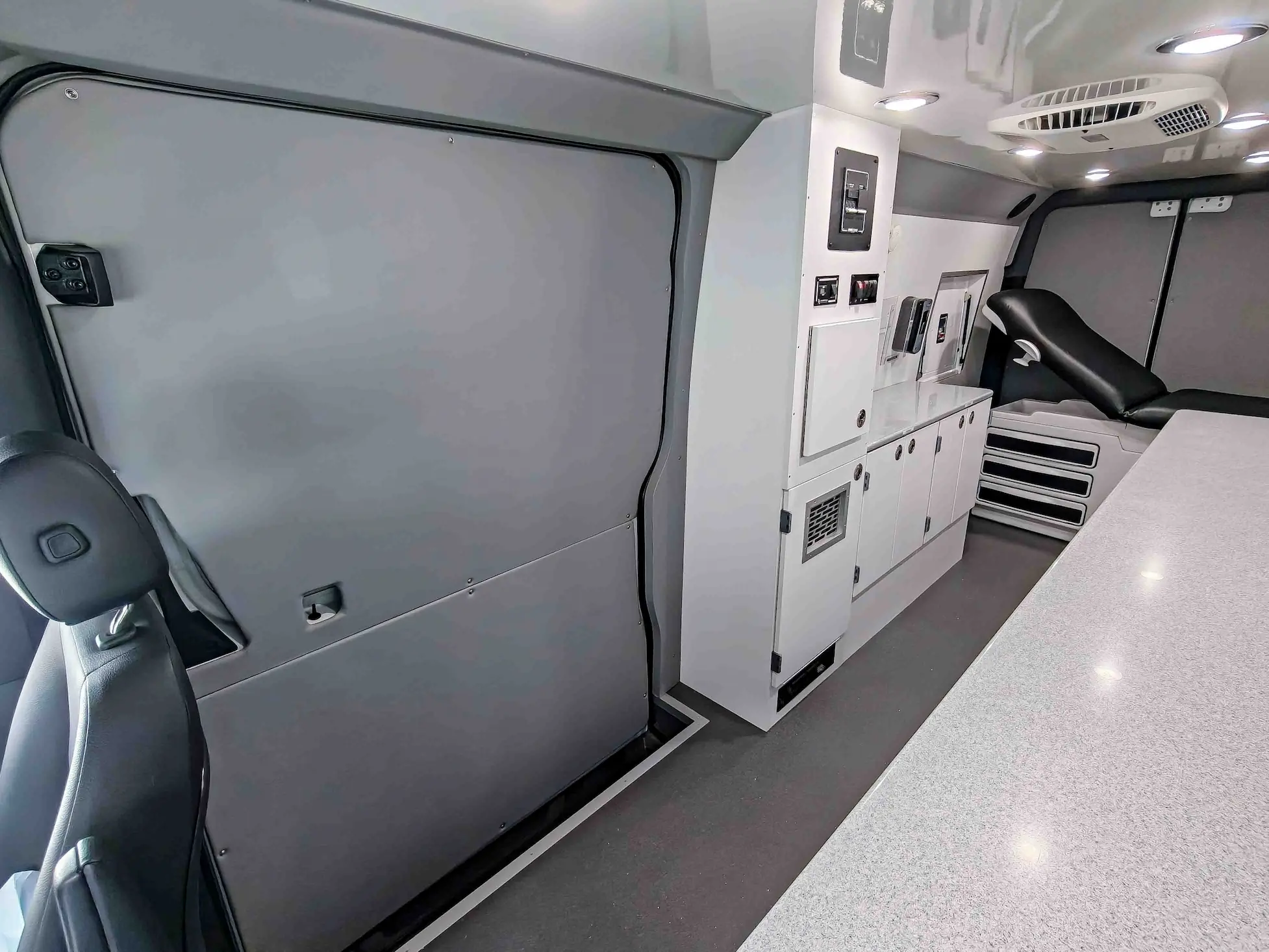 Interior with exam bed of a used 2020 Mercedes-Benz Sprinter Mobile Clinic & Testing Lab (Customizable Build) for sale