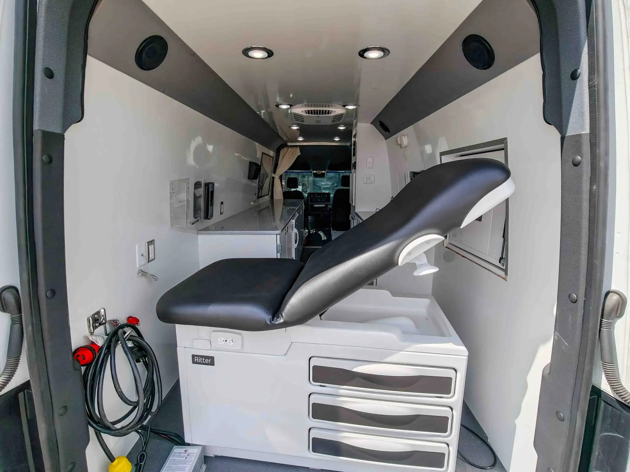 Interior with exam bed of a used 2020 Mercedes-Benz Sprinter Mobile Clinic & Testing Lab (Customizable Build) for sale