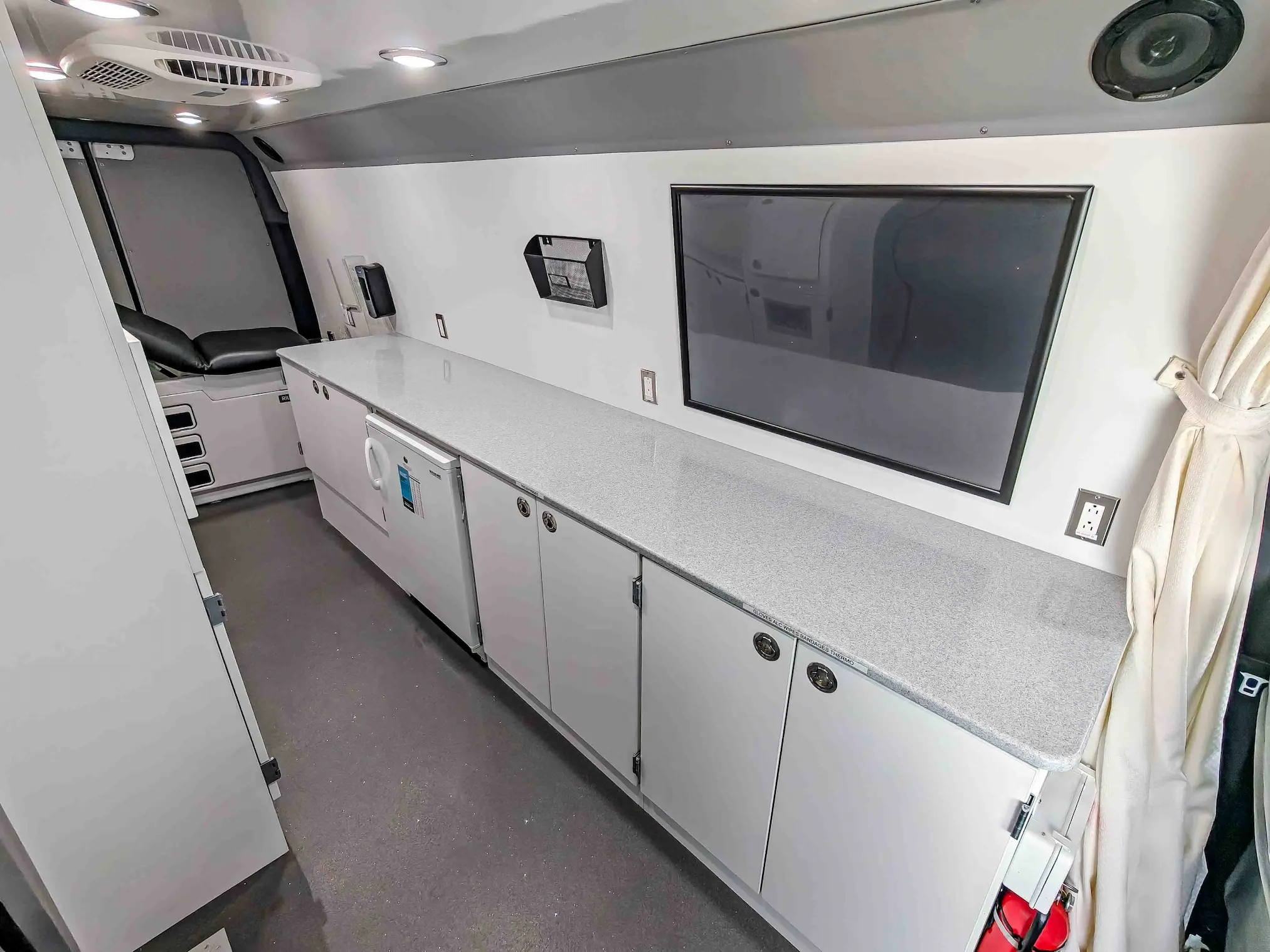 Interior with exam bed of a used 2020 Mercedes-Benz Sprinter Mobile Clinic & Testing Lab (Customizable Build) for sale