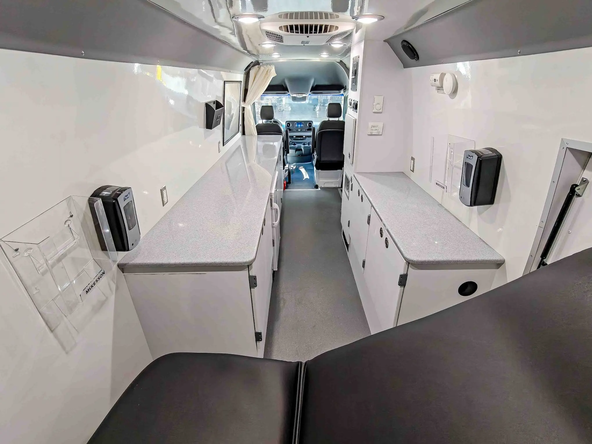 Interior with exam bed of a used 2020 Mercedes-Benz Sprinter Mobile Clinic & Testing Lab (Customizable Build) for sale
